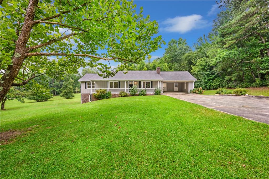 Welcome to your peaceful retreat. Where timeless brick charm meets modern comfort on a spacious 2-acre lot. This fully renovated 3-bedroom, 2-bath brick ranch is a rural gem. Blending timeless charm with modern updates, the home features thoughtful touches throughout.. from upgraded door handles and light fixtures to beautifully renovated bathrooms. The bright, open-concept living area welcomes you in, anchored by a real masonry wood-burning fireplace for cozy evenings. The stunning kitchen offers wood-stained cabinetry, granite countertops, stainless steel appliances, and two large kitchen islands equipped with cabinetry and electrical connections. Perfect for both everyday living and entertaining. A dedicated pantry includes an additional utility space ideal for storing brooms, vacuums, and small appliances. The home also boasts a convenient laundry room and a mudroom with a built-in bench with coat hooks. The full, drive-in basement provides ample storage and the potential for future expansion. The carport includes extra storage space and offers the option to be converted into a full garage, with hidden crawlspace access neatly tucked away. Outside, the expansive yard is mostly cleared with minimal trees, creating an ideal space for gardening, privacy, or playtime with kids and pets. Located in a quiet, established neighborhood with easy access to local amenities. This property offers the perfect balance of rural tranquility and modern convenience. Don't miss this opportunity to own a move-in-ready retreat with room to grow.