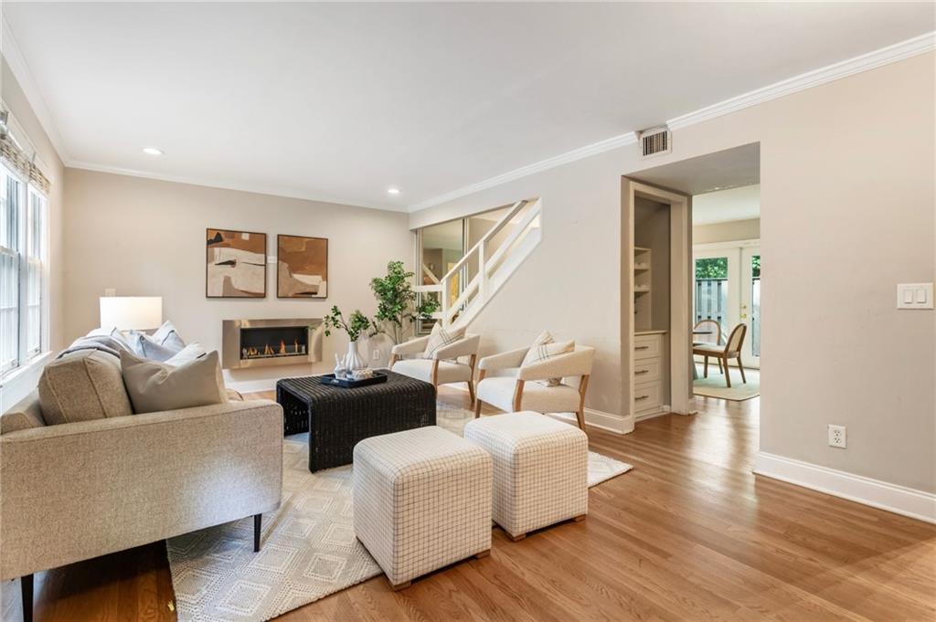 NO RENTAL RESTRICTIONS! Discover the best of Buckhead living in this beautifully updated end-unit townhome, nestled in the highly sought-after gated community of Cross Creek. Tucked away on quiet Arpege Way, this move-in ready home features real oak hardwood floors on the main level and a bright, open layout perfect for everyday living and entertaining. The renovated kitchen shines with custom cabinetry, quartz countertops, stainless steel appliances, and a tucked-away laundry with washer and dryer included. Upstairs, the spacious primary suite offers a spa-like retreat with a walk-in shower, separate jetted tub, and generous closet space, while the guest suite includes its own updated bath and walk-in closet. Step outside to your private fenced patio with pavers and turf—ideal for relaxing or hosting friends. Recent upgrades include a newer hot water heater and HVAC, updated lighting throughout and custom built-in bookshelves and closet systems. Cross Creek’s unbeatable amenities include a par-3 golf course, three pools, tennis courts, a fitness center, on-site restaurant and bar, and lush landscaping—all just minutes from Atlanta’s best dining, shopping, I-75/85, and the airport. This home truly has it all!