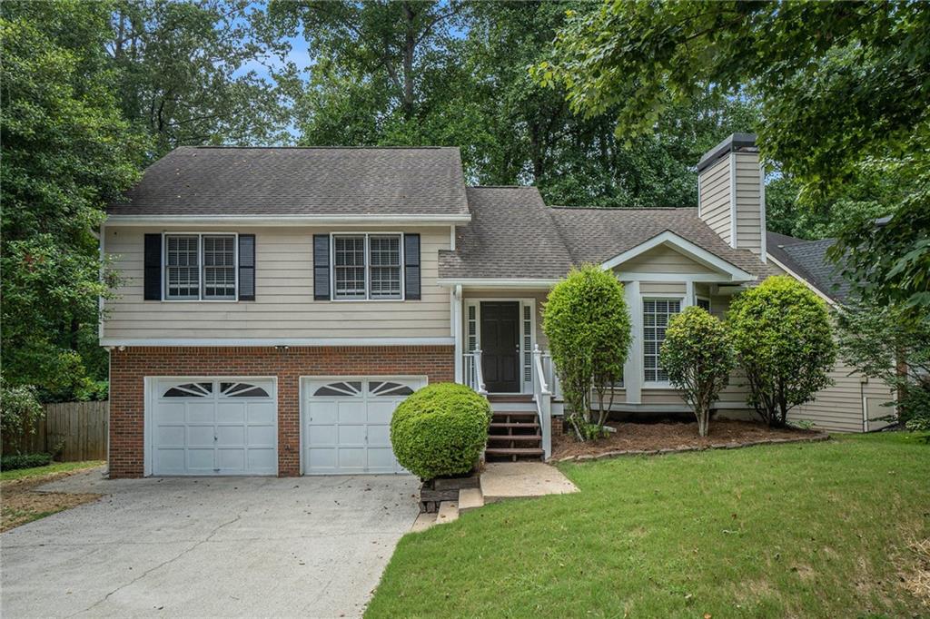 Welcome to this move-in ready gem, perfectly tucked away on a peaceful cul-de-sac in the highly sought-after neighborhood of Country Walk! From the moment you step inside, you’ll love the bright, open spaces accented by fresh paint and stylish finishes throughout. The main level features gorgeous, low-maintenance laminate wood floors and an inviting living room with soaring vaulted ceilings, a striking accent wall, bay windows that flood the space with natural light, and a cozy fireplace—ideal for relaxing after a long day. Entertain with ease in the spacious dining area with seamless access to the outdoor deck. The kitchen boasts on-trend white cabinetry and ample counter and storage space for all your cooking needs. Upstairs, retreat to the serene primary suite complete with laminate wood flooring and a private en-suite bath featuring a tub/shower combo. Two generous secondary bedrooms and a full bath provide plenty of room for family or guests. Step outside to a fully fenced backyard backing to serene woods for ultimate privacy. Enjoy an upper-level deck perfect for gatherings and a covered lower area ideal for storage. Living in Country Walk means more than just a home—it’s a lifestyle! Take advantage of incredible amenities, including a pool, tennis courts, basketball, pickleball, playground, and even a charming Country Store with gas pumps! Outdoor enthusiasts will love direct access to the Silver Comet Trail via the nearby Lucille Creek Trailhead. Plus, you’re just minutes from downtown Powder Springs for shopping, dining, and entertainment.