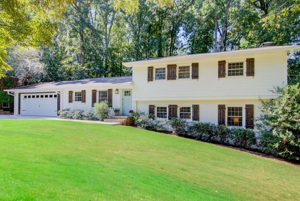 Thoughtfully designed and meticulously maintained, this spacious Dunwoody home is the one! Situated on a quiet street, moments to Georgetown Park and just minutes from Brook Run Park, the MJCCA and local shops and restaurants in Dunwoody Village. From the moment you arrive, you're greeted by professional landscaping, a newer driveway, retaining wall, and garage door (2024). Step inside to an open-concept layout designed for entertaining, featuring beautiful hardwood floors, recessed lighting, and serene wooded views of the backyard. The kitchen is a showstopper, complete with marble countertops, stainless steel appliances, a pot filler, pantry with reclaimed wood doors, white cabinetry and seamless views into the fireside living room and spacious eat-in area. Upstairs, the primary suite is a true retreat with a large walk-in closet and a spa-like en-suite bath featuring a glass-enclosed shower and beautiful tile. Two additional generously sized bedrooms and an updated full bath with abundant storage complete this level. The lower level offers even more space with a cozy family room with a wood-burning fireplace and built-ins, a large mudroom with backyard access, an additional spacious bedroom, and an updated full bath. The daylight, walk-out terrace level has been fully renovated (2022) and provides incredible flex space to fit your lifestyle. Outdoor living shines with a large screened porch, renovated patio, and a beautifully landscaped backyard perfect for relaxing or entertaining. Peace of mind comes with numerous updates, including a Newer HVAC and Water Heater, New Electrical Panel (2025), Newer Windows throughout, a whole-house water filtration system, and abundant storage. This Dunwoody gem combines thoughtful design, modern upgrades, and incredible livability making it the perfect place to call home.
