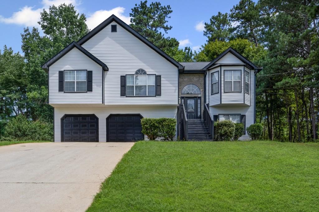 Welcome to 397 Lovejoy Circle in Powder Springs, Georgia! This beautifully renovated split-level home offers the perfect blend of modern updates and everyday comfort. Featuring 3 Bedrooms + Bonus Room and 2.5 Bathrooms, this home has been thoughtfully updated from top to bottom. Step inside to discover wood-style flooring throughout, giving the home a clean, cohesive look. The interior and exterior have been freshly painted, creating a bright and inviting atmosphere. The kitchen shines with all-new stainless steel appliances, a modern tile backsplash, and plenty of cabinet space, making it ideal for both cooking and entertaining. The spacious living room flows seamlessly into the kitchen and dining area, perfect for everyday living. Downstairs, you'll find a versatile bonus room with its own full bathroom, ideal as a recreation space, home office, media room, or guest suite. All bathrooms have been fully updated with modern tile finishes, and the renovated back deck is the perfect spot to relax and enjoy views of the peaceful backyard and surrounding nature. Additional highlights include a 2-car garage for ample storage and parking, and a location in a welcoming community close to schools, shopping, and major interstates. Don't miss your opportunity to make this move-in ready home yours. Schedule your showing today!
