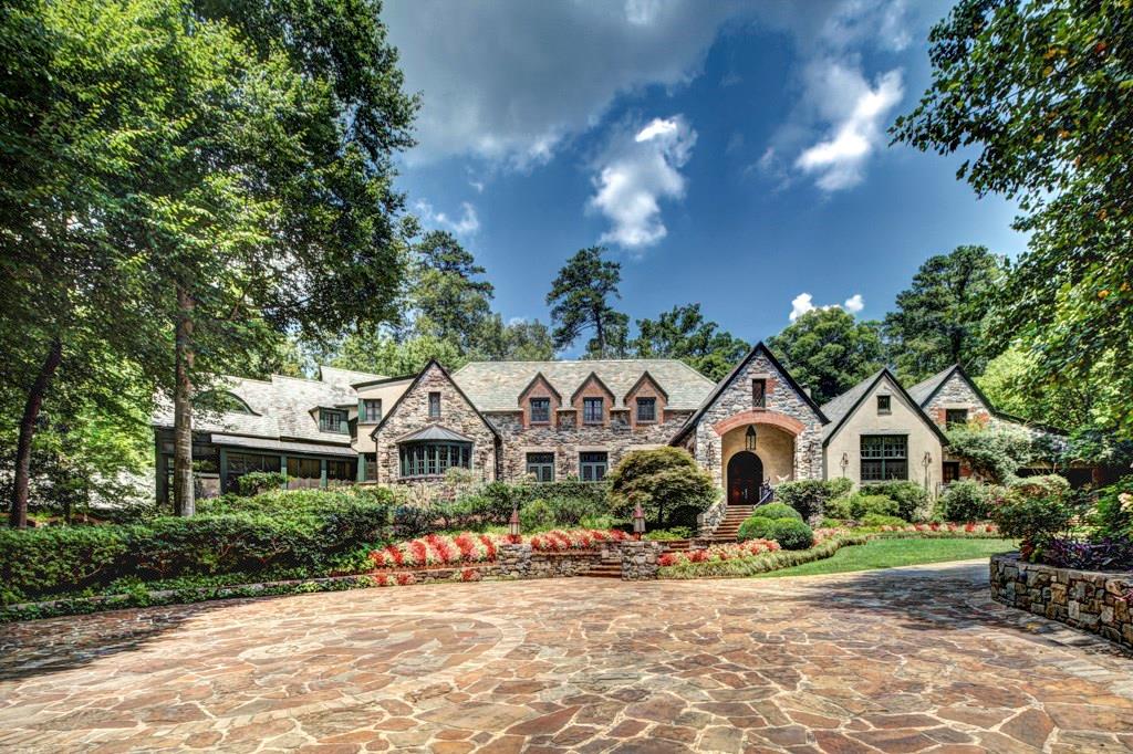 Perhaps Buckhead's best kept secret, tucked down a private gated drive this home was originally built in 1925. Professionally landscaped grounds w/ a stone bridge leading to a 3 car garage w/2 bed 2 bath guest suite above. Wonderful gardens, patios, terraces, lawn areas & screen porch. Hardwood floors, plaster walls & antique beams throughout. Restoration of the original portions, additions of great room w/soaring vaulted ceilings, breakfast & kitchen area, wine cellar, rec room, main floor master suite, children’s quarters w/sitting & play rooms, pool & pool house.