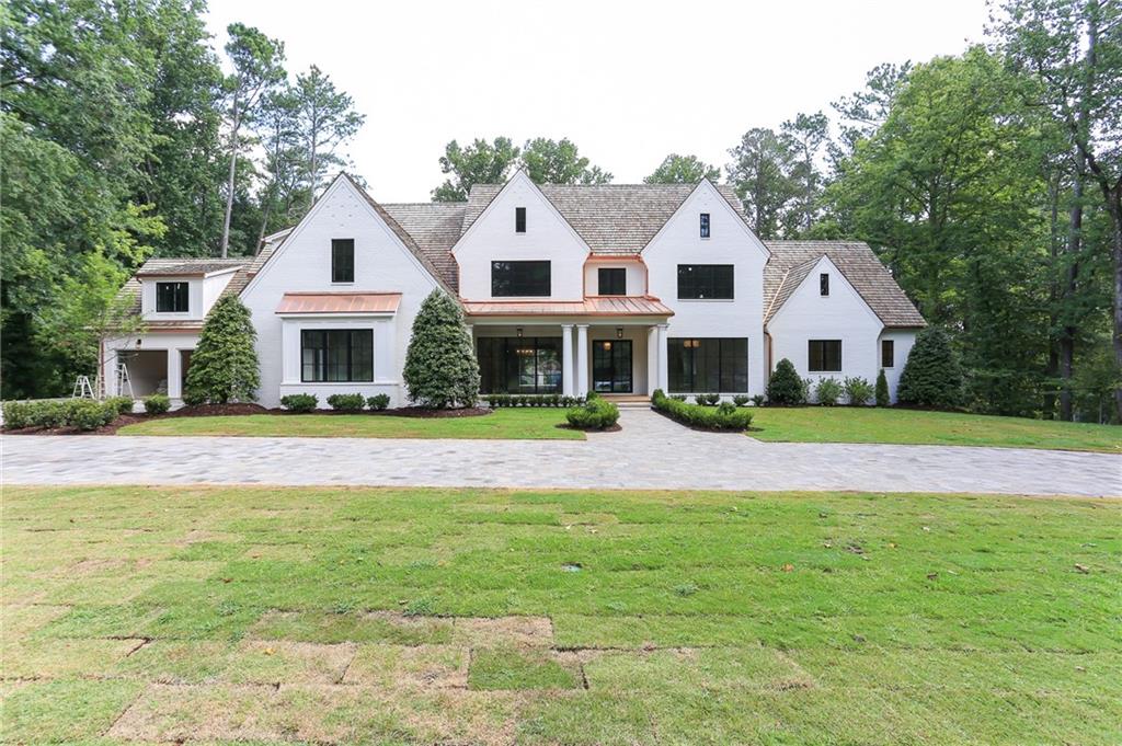 Custom new construction on private 1-acre lot with Elevator and Pool! Stunning painted brick home by North Atlanta Properties with Master on Main. Elevator to all three floors. Large open floor plan with folding glass walls in Great Room and Keeping Room create seamless indoor & outdoor living. Chef's Kitchen with marble counters, custom cabinets, Wolf/Subzero appliances, walk-in pantry, fireside Keeping Room, over-sized Great Room with fireplace and a Study. Master Suite with a morning bar. Luxurious master bathroom w/ double vanity, soaking tub, large shower, heated floors, and two walk-in closets. Upstairs there are 5 en suite bedrooms and loft. 2 laundry rooms, mudroom, home office, front & rear stairs, veranda, outdoor fireplace, heated pool, private backyard, Unfinished terrace. Sought After quiet cul-de-sac. Sq footage is on the first two floors.