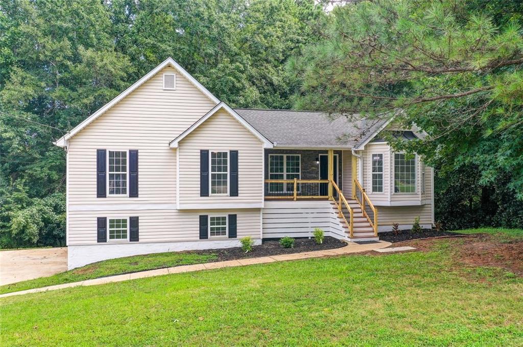 This fully renovated 3-bed, 2-bath home blends modern finishes with comfort and flexibility. Enjoy brand-new LVP flooring throughout, updated lighting, ceiling fans, and a cozy fireplace in the living room. The kitchen features white cabinets, granite countertops, sleek black appliances, matte black faucets, and black cabinet handles for a stylish, cohesive look. Both bathrooms showcase white quartz countertops, gray ceramic tile, and a beautifully tiled walk-in shower in the primary suite, complete with a large walk-in closet. Matte black faucets continue the modern design throughout. Laundry hookups are
available both upstairs near the kitchen and in the unfinished basement. The brand-new front deck and renovated back deck offer outdoor charm, while the freshly renovated 2-car garage includes brand-new doors and remote openers. The basement is framed with laundry connections and ready to be finished into a bedroom, office, or in-law suite—customize it to your needs! Located just 10 minutes from High Shoals Falls and 45 minutes from Downtown Atlanta, this
move-in-ready home offers style, space, and potential in a peaceful neighborhood.