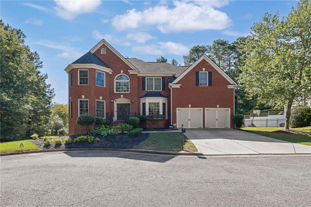 Hamilton Mill's dream community offers an unparalleled lifestyle with an array of resort-inspired amenities, including a top-tier golf course, two exclusive community areas, tennis courts, 6 pickleball courts, basketball and sand volleyball courts, soccer and softball fields, two refreshing pools with a slide and children's play areas, and a fully equipped fitness center. The Hamilton Mill clubhouse is also available for special events, ensuring exciting activities for all ages. The home itself is a spacious 5-bedroom, 4-bathroom residence located in a private cul-de-sac on a rare, oversized lot, providing unmatched privacy. Upon entering, you'll find a grand two-story foyer and wide hallway. To one side, there's a spacious office or formal living room, and on the other, a large dining room with a tray ceiling. The high-ceiling family room is perfect for gatherings. The kitchen is well-appointed with a large island offering additional cabinets, tall stained cabinets, granite countertops, and stainless-steel appliances, while the breakfast area provides an amazing view of the outdoor space. The main level includes a private guest en-suite. Upstairs, the owner's suite is a sanctuary of luxury with a double-tray ceiling and a cozy sitting room. The master bath features his and hers vanities, a garden tub, a separate shower, vaulted ceilings, and an expansive walk-in closet. Three additional well-appointed bedrooms complete this level. The home also offers 1,526 sq. ft. of unfinished living space for additional storage or future expansion. This home is a rare gem offering unparalleled luxury and comfort, ready to welcome you to a life of grandeur and elegance. Its location provides quick access to I-85, making Atlanta and its international airport just a short drive away. You'll also enjoy easy access to entertainment, shopping, and dining options in the Mall of Georgia area, just a 15-minute drive. Please let me know if you are interested in learning more about this extraordinary opportunity or would like to schedule a viewin