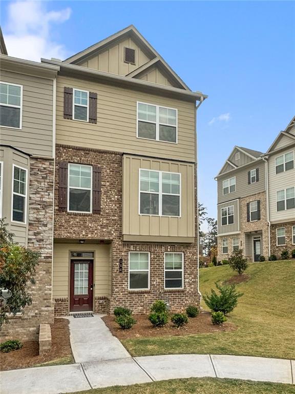 End-Unit townhome! The Rutledge Plan is a three-story townhome featuring open floorplan with a rear entry garage and a large driveway. Open-floor kitchen offers a granite island, newer appliances with a gas range, pantry, and a dining area. The family room offers crown molding, a linear fireplace, and an oversized covered deck with a gas line for your grill. The lower level offers a bedroom and full bath with a two-car garage. The third level offers a spacious owner's suite with walk-in closet, and a full ensuite with dual vanity. There are two additional bedrooms and a full bath. The Townes at Marietta is located minutes from I-75, Truist Park, Marietta Square, Kennesaw National Park and easily accessible to Smyrna, Buckhead, Midtown, and Downtown Atlanta.