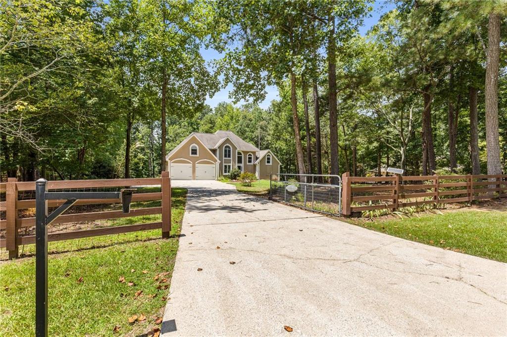 Private Gated Mini Farm on 13+ Acres — Fully Renovated Home, Fenced Pastures & Homestead Amenities
Tucked behind a private, solar-powered gate and surrounded by lush Georgia woodlands, this captivating 13-acre mini farm offers the perfect blend of luxury, functionality, and rural charm. From the beautifully remodeled kitchen to the fenced pastures, animal enclosures, and open meadows, every inch of this estate is ready for your homesteading dreams.
As you pull through the gated entrance, a long private drive leads you to a stately stucco residence framed by mature trees and meticulous landscaping. The arched windows, dual gables, and grand two-story entry set the tone for what’s inside—a tasteful blend of classic design and modern updates. The gourmet kitchen features a quartz waterfall island, farmhouse sink, subway tile backsplash, and stainless steel appliances, including a gas cooktop and double ovens, white shaker cabinetry, and built-in pantry storage. The main floor features cozy living spaces with hardwood floors and picture windows that showcase wooded views. The home offers an ideal balance of open-concept living and private retreats—move-in ready with room to grow.
Outdoor Features & Land Use
Outside, the property truly comes to life. Designed for those who love the land, you'll find:
Over 13 acres of mostly level, usable land with mature hardwoods flanking, Powder Springs Creek!
Fenced backyard and open pasture areas ideal for horses, goats, or gardening
Established raised garden beds for fresh produce
Expansive back deck for grilling, entertaining, or watching wildlife
Professionally constructed chicken coop with walk-in greenhouse and concrete block foundation
Separate storage shed and covered outbuilding for tools or feed
Natural walking trails and a cleared field perfect for a future barn, or food plots
This is a rare opportunity to own a turn-key hobby farm with room for expansion, located in a quiet pocket of estate homes with no HOA.
Location & Lifestyle
While you'll feel a world away, you're just minutes from shopping, grocery stores, parks, and top-rated schools. Enjoy the freedom of rural living with quick access to major roads.
Whether you're seeking a sustainable lifestyle, a hobby farm, or a serene retreat from suburban sprawl, this property checks every box. Live, grow, and thrive on your own private mini farm—where the possibilities are as wide as the land itself.