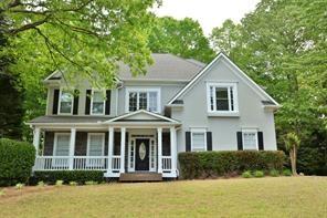 Welcome to this beautifully maintained two-story executive home, ideally located in the sought-after Wyngate at Towne Lake. Enjoy peaceful mornings on the inviting rocking chair front porch, perfect for relaxing and taking in the quiet neighborhood charm. Inside, you'll find an open and airy floor plan with gleaming hardwood floors throughout the main level. The heart of the home is the well-appointed kitchen, offering ample cabinet space, a center island, and a cozy breakfast nook overlooking the backyard. The main floor also features a dramatic two-story living room filled with natural light, a separate den or office space, and an elegant formal dining room—ideal for entertaining. Step outside to a stunning rear deck, perfect for outdoor dining or unwinding at the end of the day. Upstairs, you’ll find four generously sized bedrooms and two full baths, including a spacious primary suite with a walk-in closet and private en-suite bath. A full, unfinished basement provides abundant storage space or room for hobbies and workshop needs. The home also includes a two-car garage and is situated near top-rated schools, parks, shopping, and dining—with easy access to I-575 and all that Downtown Woodstock has to offer.