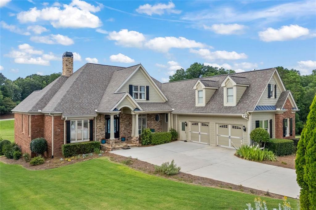 1909 Duncans Mill Ln/Rd is a four-sided brick home in Traditions of Braselton, blending modern luxury with practicality across 5,154 heated sq ft including extra storage. Highlights include a master suite on the main level, versatile rooms for office or nursery use, elegant living areas with a gourmet kitchen, spacious guest accommodations, a large upstairs suite, and a finished basement with entertainment options, gym, and workshop. Outdoor spaces feature a deck and patio overlooking landscaped gardens. The community offers clubhouse with a state-of-the-art fitness center, swimming pool, tennis and pickleball courts, golf, and walking trails. Convenient access to Jackson County schools, restaurants, retail, I-85, and Hwy. 53 ensures easy commutes to Atlanta, Flowery Branch, Gainesville, Commerce, and Athens. Recent updates provide peace of mind, making this home an outstanding opportunity for any buyer.