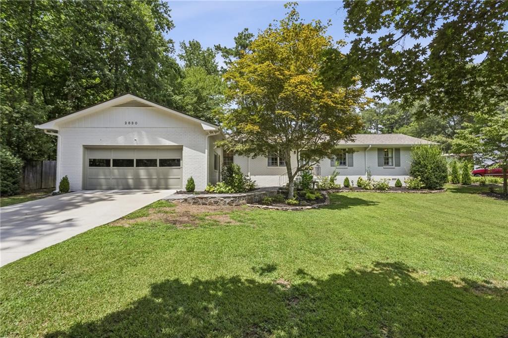 This is the hard to find 4 bed brick ranch you've been searching for! Charm oozes from this sweet cottage! The
recently updated painted exterior and carefully planned landscaping of the front yard makes for wonderful curb appeal.
Upon entering, you'll notice the gleaming refinished hardwoods that are throughout! The fireside living room has large
windows and is open to dining area for an open concept. Kitchen has loads of cabinets and pantry and window
overlooking expansive fenced in flat backyard. Three bedrooms are on one side of the home, along with a lovely hall
bath and one bedroom has ensuite bath! The primary suite located on the other side of the home has a brick fireplace
and brand new oversized spa like tiled bath to die for! The primary has lovely French doors separating it, and also
has a door that leads to the screened porch. Special treat to this unique home is it has 2 laundry areas! One in hall
convenient to guest rooms and the other in the primary bath! The backyard is a dream that has it all: flat grassy
areas, trees, two storage buildings, fenced, so many possibilities. Top sought after schools too! Close to it all, Mt.
Paran Christian, shopping, interstates, Kennesaw Mtn, Marietta Square. The homeowners have taken special care with
this one!