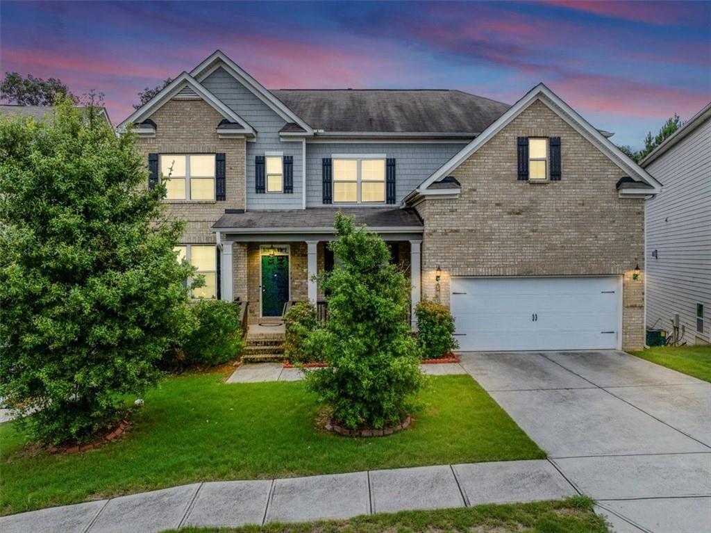 Beautiful Executive Two Story Brick Front Traditional Home! Rocking chair front porch. Grand entry foyer. Bedroom on the Main floor with Full Bath. Two Story Family Room with Wall of Windows! Open Concept Floorplan. Kitchen with Huge Island that Opens to the Family Room. Elegant Formal Living and Formal Dining Rooms. Oversized Master Suite Upstairs with Spa Like Bath. Dual vanities, soaking tub, separate shower, large walk-in closet. Two spacious guest bedrooms with Jack and Jill bath. One private on-suite bedroom. Laundry Room upstairs and right outside the master bedroom. Hardwood floors on the main floor living areas. Soaring ceilings and open and bright floorplan! Unfinished basement just waiting for your expansion. This home has so much to offer. Beautifully appointed and well taken care of by the original owners. Don't miss this beautiful property! Make it your forever home. Swim/Tennis community. Buyers ask me how you can save 25% on your attorney fees and get a free appraisal!!