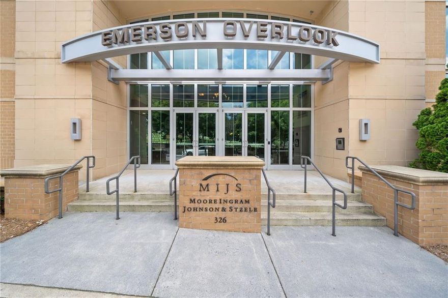 Welcome to Emerson Overlook—just steps from vibrant Marietta Square! This spacious 2-bedroom, 2-bath condo with a bonus den offers the low-maintenance lifestyle you’ve been looking for in one of Marietta’s most sought-after communities.  Watch the exciting parades right from your balcony!
Enjoy a bright, open floor plan in this large corner unit, perfect for entertaining or relaxing at home. The modern kitchen features stainless steel appliances, sleek countertops, and plenty of cabinetry. The living and dining areas flow effortlessly, and large windows offer expansive views that make this home truly special.
You’ll love the bonus den—ideal for an office or guest space—and the generous bedrooms with ample closet space. This unit includes a private storage area in the basement and two covered garage parking spaces located in a prime spot close to the entrance—a rare and convenient perk!
Residents enjoy access to an on-site fitness center and the unbeatable location—walkable to shops, dining, parks, and all the charm of Marietta Square. Easy access to major highways makes commuting a breeze.
Be sure to look at convenience of parking spots: # 103 and 104.   Large storage shed in basement is #12!