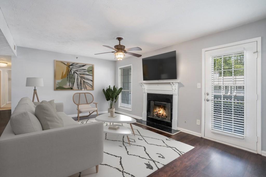Charming Condo in the Sought-After Willows by the River Community! Located in a well-established neighborhood with Resort-Style Amenities and direct access to National Forest trails, this condo offers comfort, convenience, and connection to nature all in the Award-Winning Walton High School district. Inside, you'll find New Light Fixtures/Fans and Fresh Paint throughout the entire home. Dark flooring flows seamlessly from the Fireside Family Room to the Dining Area, creating a warm and inviting main living space. The adjacent Kitchen is equipped with Granite Countertops, Stainless Steel Appliances, and everything you need for everyday living and entertaining. Two spacious bedrooms and Two Full Bathrooms offer flexibility for roommates, guests, or a private home office setup. Step outside to your private covered patio, perfect for relaxing, grilling, or enjoying your morning coffee. Enjoy access to a community Pool, Fitness Center, Playground, Tennis Court, and Grilling Area, all just steps from your front door. With easy access to Marietta, the Perimeter, Vinings, and more, this is an opportunity you don't want to miss!