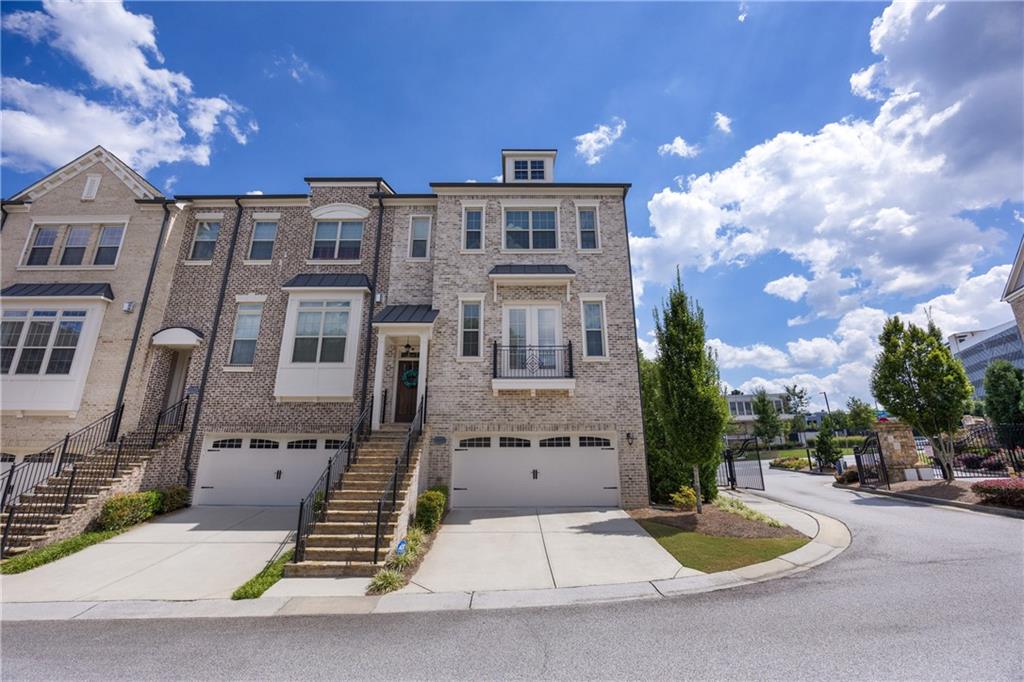 ***RARE PRIVATE END UNIT*** BE SURE TO WATCH THE STUNNING VIDEO TOURS*** Watch Braves Fireworks from Your Deck! This is where where location, lifestyle, and luxury collide! This stunning, impeccably maintained end-unit townhome offers the rare perk of watching fireworks from Truist Park right from your back deck. Inside, you’ll find gleaming hardwood floors throughout with no carpet anywhere and a thoughtful three-story layout designed for comfort and entertaining. Speaking of entertaining, the centerpiece of the home, the kitchen, boasts a 8ft center island with gleaming quartz countertops, custom glass backspash, stainless steal applainces, 42 inch cabinetry with crown molding toppers, touch-less faucet, and upgraded hardware - all opening to the dining and living room! The terrace level is a true showstopper, with an open space perfect for hosting game days, movie nights, or casual gatherings. Hand crafted, oversized "drop zone" for coats and hats, built in Murphy bed (stays with home) that can convert to a guest suite + a full private bathroom. Bonus glass door leads to finished concrete patio under the deck, perfect for grilling and access to the largest yard in the neighborhood (thanks to being an end unit). Storage EVERYWHERE...huge closet and added storage space in the 2 car garage (not all townhomes have this feature). The primary suite is a true retreat, featuring a designer accent wall and a spa-like bathroom with an oversized frameless glass shower. Enjoy a lush, green lawn thanks to built in irrigation.
Live steps away from the action and walk to The Battery, Braves games, and top dining spots like Superica, Yard House, and Punch Bowl Social. Catch a show at The Fox or explore the Chattahoochee River trails, all just minutes away. Easy access to I-75 and I-285 keeps the rest of Atlanta at your fingertips.
This one checks all the boxes: location, upgrades, and unbeatable lifestyle. Don’t miss it!