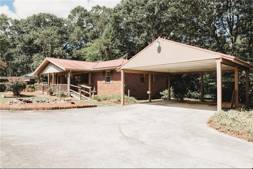 Charming One-Level Home on Over 2 Acres- Discover the perfect blend of comfort, privacy, and convenience in this beautifully maintained one-level home nestled on over 2 acres of land. Just minutes from the interstate, this property offers the ease of access you need with the peaceful surroundings you desire. The interior provides original, beautifully aged hardwood floors that add warmth and character throughout the home. Enjoy multiple living spaces, including a sunroom perfect for year-round enjoyment, a welcoming front porch, and a screened-in side porch ideal for relaxing evenings. The exterior is a true highlight, featuring a mature landscaped lawn, a private setting, and thoughtful amenities such as a fenced dog run, a large detached carport, a spacious 3-car garage/workshop, and a dedicated garden area ready for your green thumb. Whether you're looking for a peaceful retreat or a functional homestead with room to grow, this property has it all. Schedule your showing today!