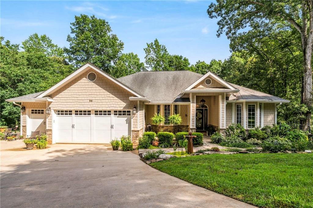 Craftsman ranch on 1.9 + acres in a private Lake Lanier neighborhood minutes from GA 400 with no HOA. Hardwood floors, 10'+ ceilings, double-sided wood-burning fireplace and transom-topped casement windows throughout the main level, with thoughtfully detailed and rarely available smooth corner walls. Primary Suite is a sanctuary unto itself with its wood paneled walk-in closet and a spa bathroom complete with an arched ceiling and lots of natural light. French doors open to a covered screen porch, perfect for chilly fall mornings, watching nature, or just listening to a rainy night in Georgia—additional guest bedroom with private bath on the main level, plus a half bath in the hall. Large living space on the terrace level with a kitchenette makes entertaining a breeze. 2 additional bedrooms, a large office/media flex space, a full bath, and walk-in storage finish out the sun-filled walk-out level with french doors that open to a spacious covered porch. Creek branch with natural spring runs through the middle and empties to the lake. Like the house? Wait until you see the gardens. Meticulously planned to be surrounded by constantly blooming heirloom plants, every day is an adventure. So many species of iris, day, tiger, and Asiatic lilies, Lenten roses in the winter, azaleas and Chinese Cherry trees in the spring, hydrangeas showing out in the summer, and Aster from the Atlanta Botanical Gardens heralding fall. The perfect amount of space for your favorite vegetables next to the established herb garden. The pool and the decks are just icing on the cake...(You will be surprised how much you like that pool...)
