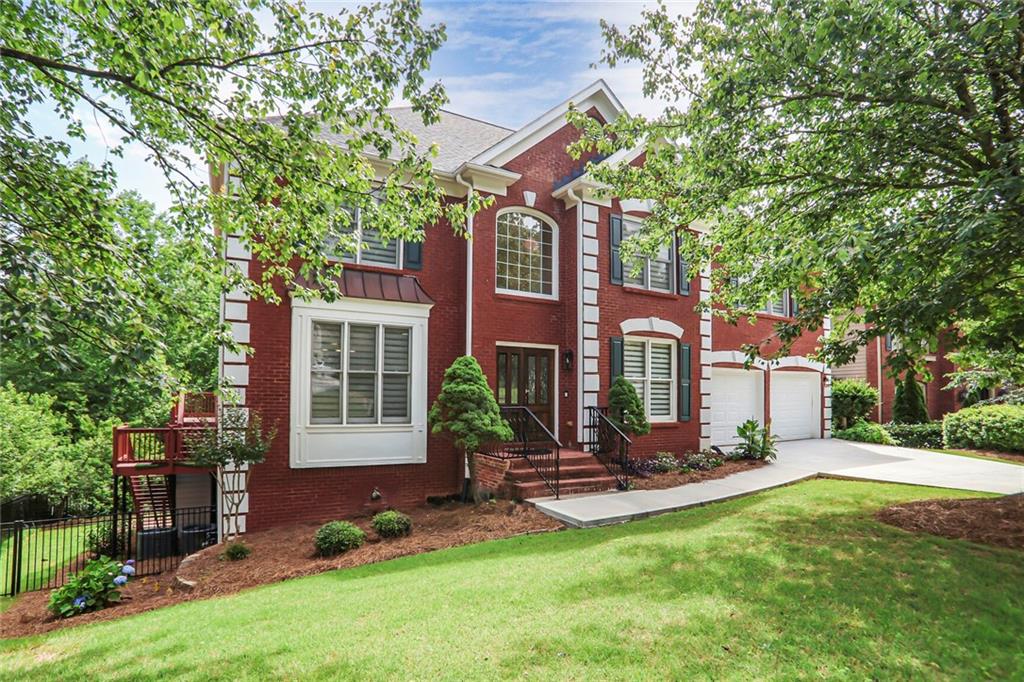 Discover this stunning two-story home with breathtaking lake views, visible right from the living room through expansive bay windows that flood the space with natural light. A grand two-story foyer welcomes you with a warm and pleasant feel, setting the tone for the rest of the home. The main level features beautiful hardwood floors throughout, creating a timeless and inviting atmosphere. The kitchen is truly the heart of this home, showcasing original stained solid wood cabinetry—a rare find today—along with ample storage, a cozy breakfast area, and seamless flow into the spacious formal dining room and adjoining library, perfect for both everyday living and entertaining. Enjoy serene outdoor living with a screened porch and a rear deck overlooking the peaceful lake—ideal for relaxing or hosting guests. The home offers 4 spacious bedrooms and 5 bathrooms, including an oversized primary suite with a luxurious spa-like bath featuring a frameless glass shower, soaking tub, and a large walk-in closet. Upstairs, you’ll find generously sized secondary bedrooms—one with a private ensuite bath, two with a convenient Jack and Jill bath—and a full laundry room for added convenience. The finished basement is truly a highlight, with soaring 9-foot-plus ceilings that showcase the strength of the engineered structure. It offers abundant space for entertaining, cooking out, and even includes a private sauna for ultimate relaxation. With its flexible layout, the basement offers countless possibilities for customization. Located in the highly sought-after Sugar Mill community in Johns Creek, this home offers access to top-rated schools, a desirable lifestyle, and is surrounded by preserved, timeless nature. Don’t miss this exceptional opportunity to live in one of the most prestigious and well-loved neighborhoods in the area.