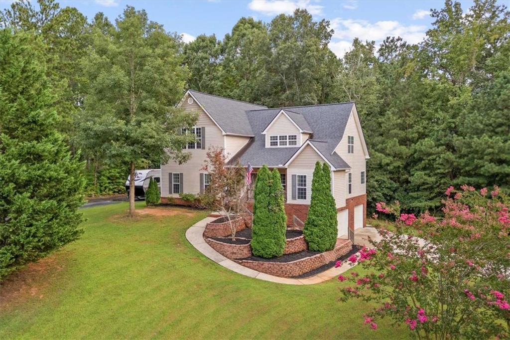 More space. More storage. Less money. This 5-bed, 4.5-bath stunner in The Oaks gives you luxury upgrades, a finished basement, and a private wooded backyard-at a price you won't believe. This corner-lot beauty offers a rocking-chair front porch, spacious living room with shiplap fireplace, and a chef's kitchen with stone counters, island, stainless appliances, and breakfast nook. Main-level owner's suite features a sitting area and spa-style bath. Upstairs-three oversized bedrooms, two sharing a Jack-and-Jill bath, and one with a private bath. Finished basement adds a bonus room, bedroom, and full bath-ideal for guests or in-laws. Enjoy a large 2-car garage, extra storage space next to the garage, two separate driveways, and a private wooded backyard with a deck for relaxing. Zoned for the highly desirable school systems of Whitesburg Elementary, Central Middle, and Central High.