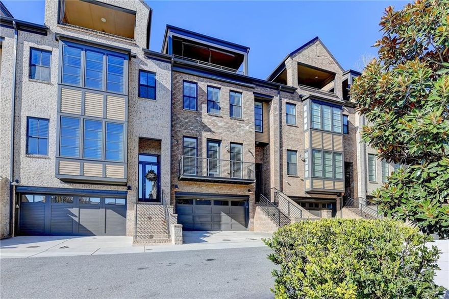 This brick modern townhome boasts a PRIVATE, fenced backyard accessible from the main living area, perfect for outdoor entertaining.  Enjoy the panoramic city views from the expansive ROOFTOP TERRACE, for nights under the stars.  The chef's kitchen is equipped with quartz countertops, a spacious center island, and a walk-in pantry.  High-end appliances and ample cabinet space for culinary enthusiasts.  The oversized master suite features a sitting area, a wall of windows for abundant natural light, and an enormous walk-in closet.  The spa-like master bath includes a soaking tub, and a separate shower providing a serene retreat. This home includes an ELEVATOR servicing all levels.  Harwood flooring throughout.  Th upper level offers a private bedroom and bath for your guests.  The billiards/entertaining room opens to the rooftop terrace.  The "Bridgeport" floor plan is the LARGEST in the community.
OVERTURE at ENCORE is a gated community offering residents exclusive access to the swimming pool, clubhouse, green spaces, and walking trails.  Located close to Avalon, downtown Alpharetta, and GA 400.