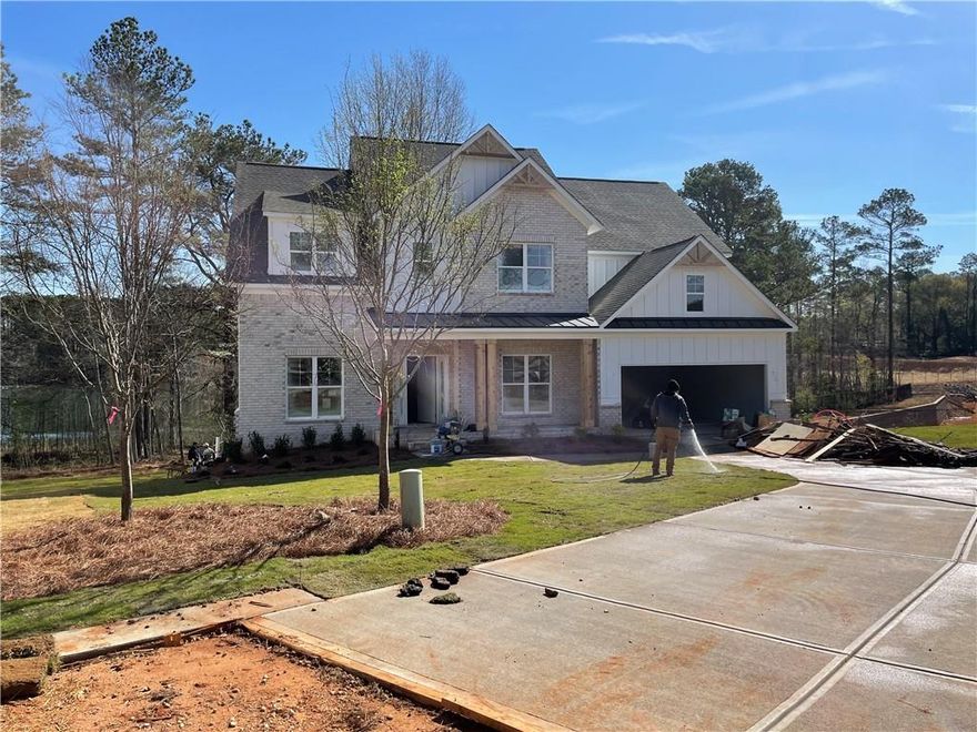 Explore the impressive Garrison Craftsman-style floor plan featuring 5 bedrooms and 4 baths. The home welcomes you with formal living and dining rooms that seamlessly flow into the kitchen, highlighted by a spacious island. The breakfast area offers a delightful view of the private backyard from the covered deck that overlooks beautiful Powers Lake. Inside, you'll find white shaker cabinets, a double oven appliance package, and elegant quartz countertops. The main living areas feature gleaming hardwood floors, adding a touch of luxury to the space. On the main level, there's an office or bedroom along with a full bath for added convenience. Upstairs, you'll discover the spacious master suite, a bedroom with its own private bath, and two generously sized bedrooms that share a bathroom. The large lot provides privacy and best part there are no HOA fees!

Beautiful Enclave of 4 homes tucked away on private drive.

RELAX ON YOUR COVERED DECK WITH AMAZING VIEW ON POWERS LAKE.  A DREAM COME TRUE FOR THOSE WHO WANT A QUITE AND PRIVATE BACKYARD!!!