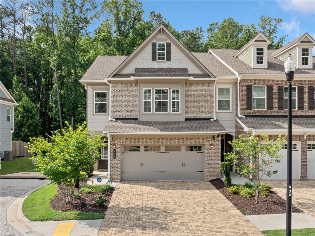 Experience effortless, upscale living in this move-in ready end-unit townhome, ideally located in the coveted Artisan community in the heart of Alpharetta. Step inside to a light-filled, open layout thoughtfully designed to balance everyday comfort with effortless entertaining. The chef’s kitchen is the heart of the home, featuring a large granite island, stainless steel appliances, and plenty of cabinet and pantry space. Enjoy casual mornings at the breakfast bar or gather in the dining area for more formal meals and special celebrations. French doors provide effortless access to the private backyard patio—ideal for al fresco dining or quiet evenings outdoors. A wall of windows lines the living room, filling the space with natural light, while the fireplace serves as a warm and inviting focal point. Upstairs, the spacious primary suite offers a peaceful retreat, highlighted by a tray ceiling and an oversized walk-in closet. The spa-inspired bathroom features a soaking tub, glass-enclosed shower, and dual vanities for a luxurious touch. Two additional bedrooms and a full bath offer room for guests, family, or a home office, plus you’ll love the convenience of an upstairs laundry room. Step outside to your own private, backyard with a charming patio and green space—perfect for morning coffee or playing with your furry friends. This home is equipped with modern smart home technology designed for convenience, security, and efficiency. Enjoy enhanced internet performance with top-of-the-line Ruckus switches, and easily manage your indoor climate from anywhere with the Honeywell Home T4 programmable thermostat and mobile app controls. The home also features a smart Schlage front door lock, garage keypad and remote entry, a Ring doorbell system, and a built-in alarm system for added peace of mind. All energy-efficient appliances are included, making this home as practical as it is comfortable. Residents also enjoy a community pool and playground for added fun. Located just minutes from Avalon, Downtown Alpharetta, Ameris Bank Amphitheatre, and North Point Mall, whether you're grabbing dinner, catching a concert, or enjoying a weekend stroll, everything you need is right around the corner. Enjoy top-rated North Fulton schools, quick access to GA-400, the Alpha Loop, and Greenway trails, plus the added bonus of being near the highly regarded Fulton Science Academy. Move-in ready and full of charm, this townhome checks every box. Come see it for yourself and fall in love! Seller offering $5,500 lender credit with acceptable offer via preferred lender Thomas Cady - Onward Home Mortgage, NMLS: 1017319.
