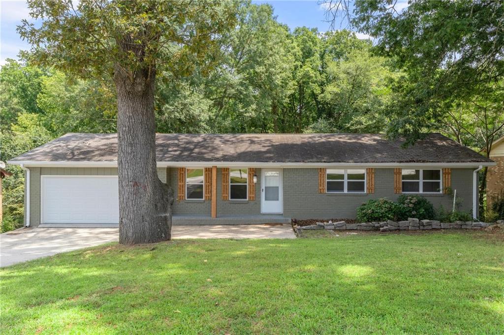 Completely Remodeled and Updated all Brick Ranch Home on a Full Basement! This quaint all brick home is perfect for the person or persons wanting a great location with the ability to expand into the unfinished basement that could easily be more bedrooms or a perfect spot for a game room, office or ample storage space! With brand new flooring, cabinets, appliances, light fixtures, HVAC, and bathrooms with tiled showers; this is the best buy in a location close to I-20, downtown historic Conyers, and the business district with all of the great shopping and dining! Three great bedrooms and two full baths help make up this spacious home with no steps on the main level! The gorgeous new LVP flooring and the updated kitchen with all new cabinets and appliances are ready for the new owner to take possession! Water heater is less than 4 years old! Basement opens up to a large, fenced backyard ready for you to put your personal touches on! Quaint front porch is great for a rocking chair to enjoy the beautiful Georgia evenings! All new windows throughout this well-built home as well! Brand new garage door on the 2-car garage too! Nothing Beats an All-Brick Home on a Full Basement in Conyers Georgia! Call us now for more information or contact your favorite agent for a showing today!