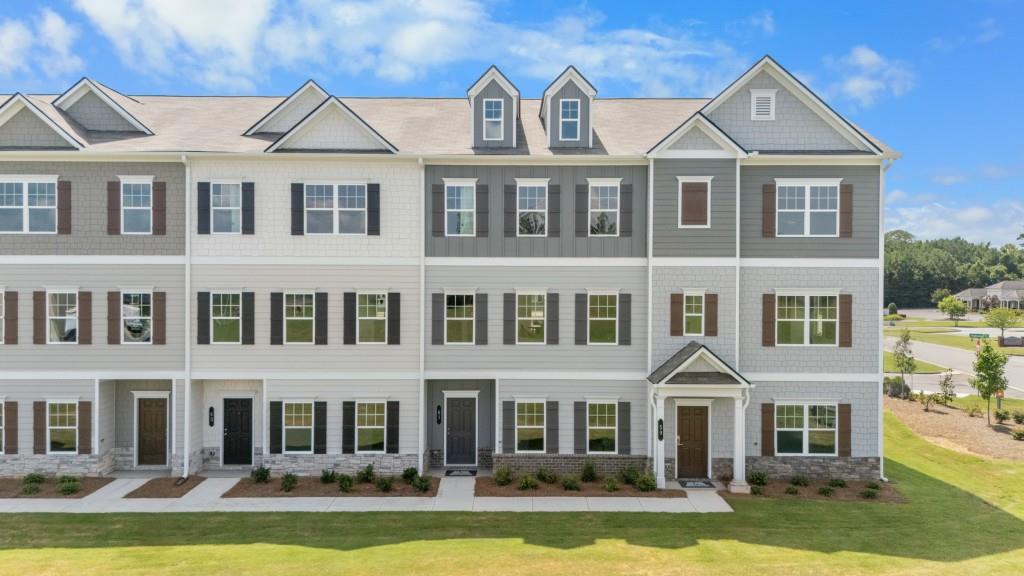 Move in Ready! The Richmond townhome, located in Smith Douglas Homes Sterling at The Villages. This plan is a two-car garage townhome with a modern design offering plenty of space. The first floor has a flex space ideal as an office, media room or playroom. The primary living space is on the second floor where the main living area boasts an open-concept seamless layout with a family room at the front of the home, dining area, an island kitchen with granite counters and upgraded cabinetry with crown molding that opens to the balcony. Vinyl Plank flooring throughout the main living area. Open iron rail staircase leads upstairs to the owner's suite which is situated at the rear of the home for added privacy and the owner's bath has a large tiled shower. Two bedrooms and a shared full bath complete this level. All floors have 9ft ceiling heights. Seller incentives with the use of one of our preferred lenders. Photos are representative of home.