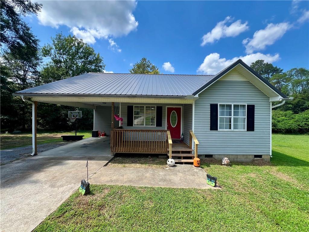 Beautiful 3-bedroom, 2-bath home in a convenient location with easy access to Calhoun, Adairsville, Rome, and I-75. Perfect for first-time home buyers! Enjoy a welcoming country-style covered front porch, ideal for morning coffee or relaxing evenings. The nearly 1-acre lot is just minutes from downtown Plainville and features a carport for covered parking, a small shed for tools, and low-maintenance vinyl siding. Inside, you’ll find a spacious living room, an eat-in kitchen with rear deck access for outdoor dining, and gorgeous tile in the kitchen and master bath. Large windows allow natural light to pour in throughout the home. Recent updates include shared bathroom remodel, roof and water heater (2019), and HVAC (2017). Seller is offering a $5,000 credit to be applied toward updates, closing costs, or a rate buy-down. Move-in ready and waiting for its next family!