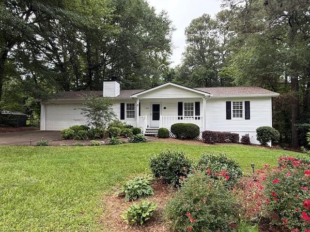 Charming 3 bedroom, 2 bath ranch in Alpharetta! Enjoy this adorable home with spacious yard! Family room with stone fireplace opens to eat-in kitchen, wooden deck and fenced backyard for added privacy. Features a new roof and luxury vinyl plank flooring throughout. Precious front porch, 2 car garage with workshop space. Move-in ready! Conveniently located and benefiting Cherokee County taxes. Freehome Elementary, Creekland Middle, Creekview High School district.