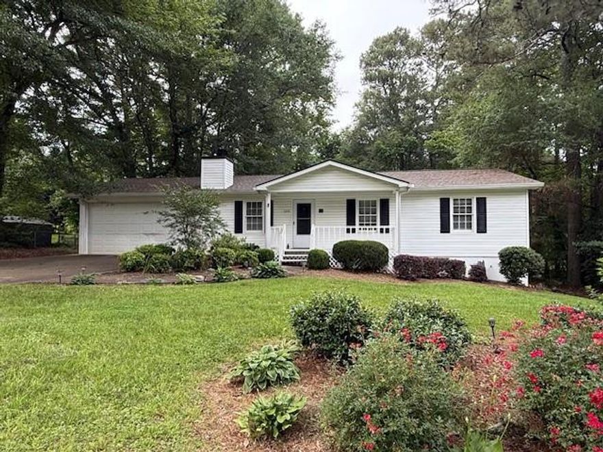 Charming 3 bedroom, 2 bath ranch in Alpharetta! Enjoy this adorable home with spacious yard! Family room with stone fireplace opens to eat-in kitchen, wooden deck and fenced backyard for added privacy. Features a new roof and luxury vinyl plank flooring throughout. Precious front porch, 2 car garage with workshop space. Move-in ready! Conveniently located and benefiting Cherokee County taxes. Freehome Elementary, Creekland Middle, Creekview High School district.