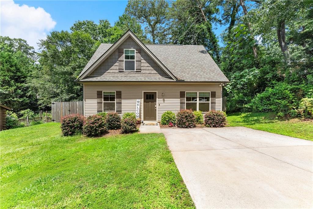 No HOA! Welcome to this charming and beautifully updated 3-bedroom, 2.5-bath home located in scenic middle Forsyth County. Thoughtfully designed with comfort and functionality in mind, this home features an open floor plan that seamlessly connects the living, dining, and kitchen areas, making it perfect for both everyday living and entertaining. The eat-in kitchen boasts stainless steel appliances, granite countertops, ample cabinet space, and large center island with additional seating—ideal for casual meals or hosting friends and family. The open layout ensures you can stay connected with guests while cooking, and direct access to the patio allows for effortless indoor-outdoor entertaining. The Master on main offers a relaxing retreat with an en-suite bath featuring granite double vanities, a bath/shower combo, and walk-in closet. Upstairs, two secondary bedrooms and a full bath provide plenty of space for a growing family, overnight guests, or a home office setup. The private, fenced backyard is perfect for pets, gardening, or simply enjoying peaceful outdoor moments. Additional highlights include updated finishes throughout, modern fixtures, and neutral tones ready for your personal touch. Whether you're a first-time homebuyer, a growing household, or a retired couple looking to downsize without sacrificing quality, this home checks all the boxes. Located just minutes from GA-400, top-rated Forsyth County schools, shopping, dining, medical facilities, parks, and the recreational paradise of Lake Lanier, this property combines comfort, convenience, and lifestyle in one outstanding package.