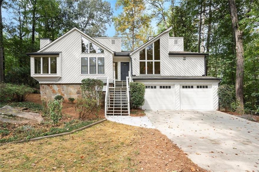Welcome home to a stunning fully renovated home in the heart of East Cobb. Blending modern design with timeless comfort, this home has been completely reimagined inside and out. Step into the open-plan living room, where soaring vaulted ceilings, contemporary windows, and a marble-surround fireplace create a light-filled gathering space. The designer kitchen is a chef’s dream with white shaker cabinets, quartz countertops, a custom vent hood, and stainless-steel appliances including a 36” range and farmhouse sink. The eat-in dining area seamlessly connects an open-air deck via the kitchen and spacious screened porch via the living room, ideal for entertaining or enjoying peaceful evenings at home. Retreat to the private primary suite, complete with its own deck, large walk-in closet, and a spa-inspired ensuite bath featuring a glass shower with designer marble tile, double vanity with quartz counters, and stylish matte black finishes. Secondary bedrooms and baths have been fully renovated with fresh tile, vanities, and fixtures. The finished terrace level offers flexible living space—perfect for a media room, home office, or guest suite—with a newly renovated full bathroom. Every detail has been carefully curated: new flooring throughout, soft-close cabinetry, upgraded lighting, new HVAC and water heater, and professional landscaping with mature foliage. The newly painted exterior, updated deck railings, and new garage doors complete this turn-key property. Located minutes from parks, shopping, and dining, this East Cobb gem combines everyday convenience with elevated design. Don’t miss your opportunity to call this beautifully renovated home your own!