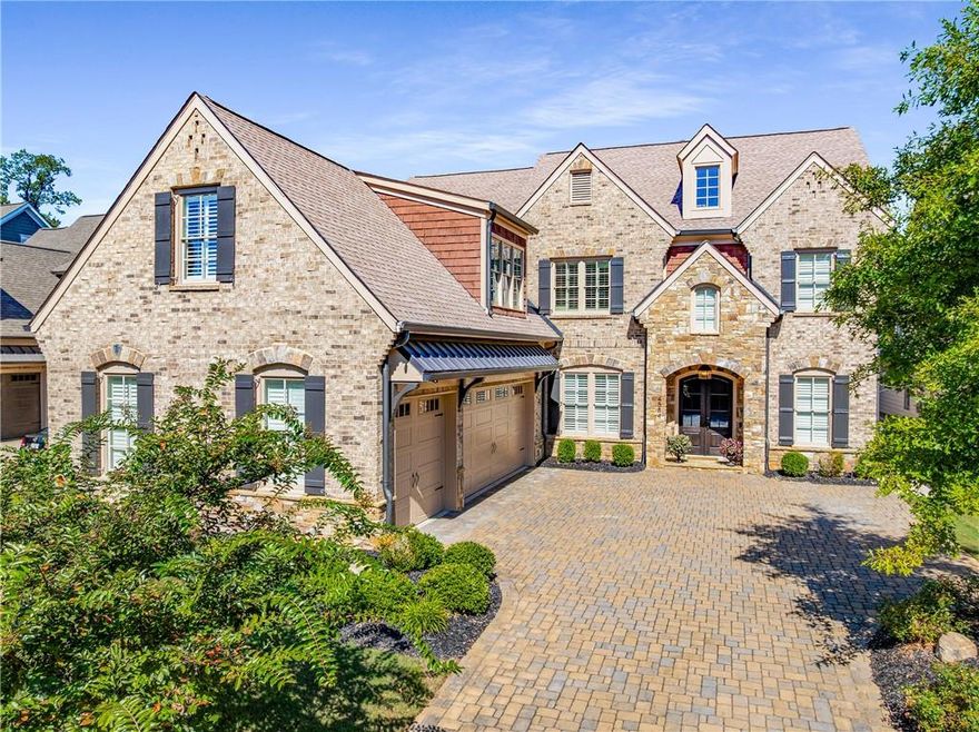 Welcome to this stunning 5-bedroom, 5.5-bath estate nestled in one of East Cobb’s most sought-after neighborhoods. This impeccably maintained home blends timeless architectural elegance with modern luxury and comfort, offering over 5,000 square feet of beautifully designed living space and impressive outdoor amenities. Drive up in style on the elegant paver stone driveway leading to a welcoming arched front entryway, beautifully framed in stone with a double door and an attached three-car garage offering ample parking and storage.
 
Step into the inviting foyer that sets the tone for this elegant home, featuring a spacious dining room perfect for hosting holiday gatherings. You'll love the open floor plan with soaring ceilings and a seamless flow into the expansive family room, complete with a cozy fireplace and custom built-in bookshelves.
The gourmet kitchen is a true showstopper, boasting a massive island, professional-grade stainless steel appliances, and a wine refrigerator—ideal for entertaining. Adjacent to the kitchen, the sunlit breakfast room opens onto a covered porch with its own fireplace. This beautifully designed covered outdoor living space that seamlessly blends comfort, style, and function — perfect for year-round entertaining or relaxing with a Retractable screen that allows this patio to convert into a semi-enclosed sunroom while still enjoying the view of the private fenced in yard.
This unique floor plan offers not one, but two luxurious owner’s suites—one on the main level and another upstairs—perfect for multi-generational living or hosting guests in comfort. The main-level owner's suite features a spa-inspired bathroom with a free-standing soaking tub, frameless shower, and double vanity. The upper level owners suite has an oversized frameless shower and double vanity providing comfort and privacy for family or visitors. Additional standout features include a generous main-floor laundry room/ home office with abundant cabinetry for maximum storage and organization.
Upstairs, you’ll find three spacious secondary bedrooms, each with its own private bathroom, as well as a versatile loft/bonus room—ideal for a media space, playroom, billiard room. Enjoy low-maintenance living at its finest, with lawn care and trash service conveniently included in the HOA. The community also features a charming park area—perfect for walking the dog, playing catch, or simply relaxing outdoors.
This is a rare opportunity to own in a quiet, close-knit community of just 21 newer homes, where turnover is uncommon. Located in the highly sought-after Sope Creek, Dickerson, and Walton school districts, and close to shopping and popular restaurants, this home offers both luxury and location. Several photos in this listing are virtually staged.