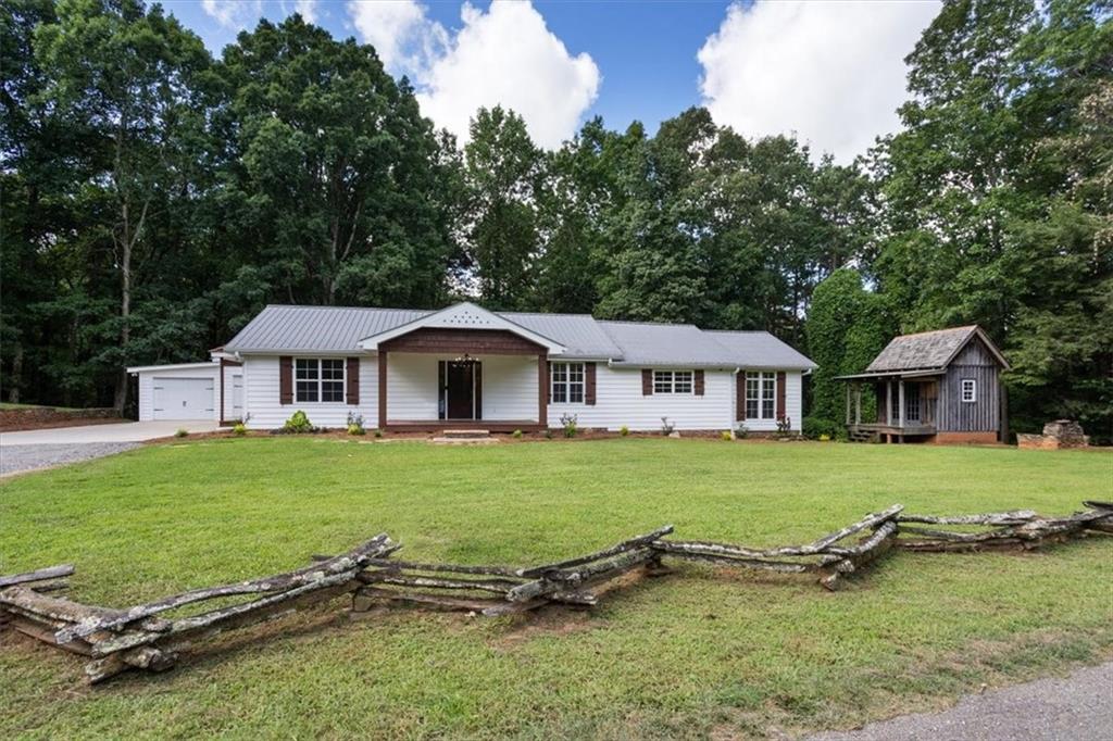 Move-In Ready Ranch in Highly Desired Clayton Community on 1.64 Acres
Welcome home to this beautifully renovated and maintained 3-bedroom, 2-bathroom ranch. Sitting on a spacious 1.6-acre lot with a creek, this 1,532 sq ft home offers the ideal blend of comfort, functionality, and scenic charm.
Step inside to find a bright and inviting layout featuring modern updates throughout, while still maintaining a warm and welcoming atmosphere. The kitchen has been thoughtfully renovated offering both style and functionality for everyday use. Just off the kitchen enjoy a light filled sunroom perfect for year-round relaxation! Both bathrooms have been renovated to provide a clean, fresh feel and comfortable use. The entire home reflects true pride of ownership.
Enjoy an evening of relaxation on the screened-in porch, just off the attached 2-car garage that includes an additional storage room for convenience. The property also features a versatile outbuilding with a loft, perfect for hobbies, a workshop, or extra storage—plus a storm shelter tucked beneath for peace of mind. The home has a fenced area, ideal for pets, gardening, or play.
Located just minutes from town, you'll appreciate the easy access to shopping, dining, schools, and a park all while enjoying the privacy and space of country living.
Don't miss this rare opportunity to own a move-in ready home in one of Clayton's most desirable areas—schedule your showing today!