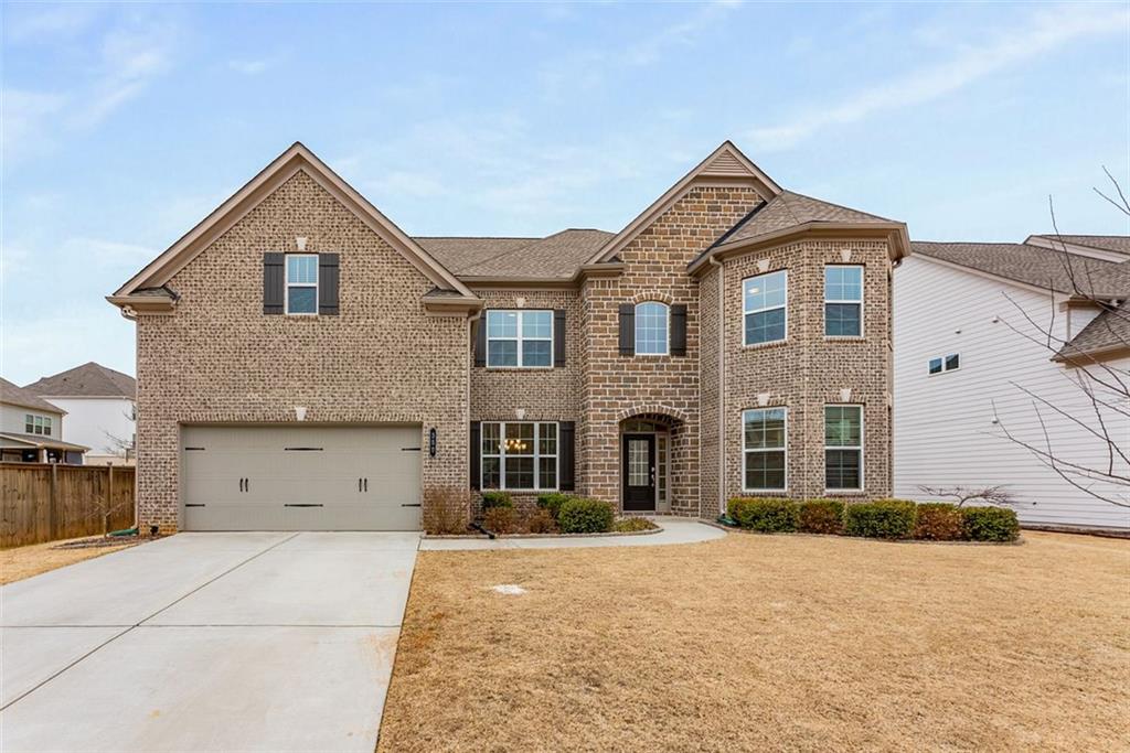 Highly sought after West Cobb neighborhood at Parkside Meadows community. Step into this beautifully designed traditional brick-front home with an elegant natural stone accent entry, offering both curb appeal and timeless charm. Boasting an open floor plan with 10-foot high ceilings on the main level, this home provides a perfect blend of spaciousness and style.
The oversized master suite is a true retreat, complete with a large walk-in closet and a spa-like ensuite featuring a double vanity, separate soaking tub, and shower. Additional bedrooms are generously sized, while the media room offers the perfect space for entertainment or relaxation. The chef’s kitchen is a dream, featuring solid surface counters, a large island, a pantry, and beautifully stained cabinets. High-end appliances include a gas cooktop, electric oven, microwave, and dishwasher, making meal prep effortless. The separate dining room is ideal for hosting gatherings, while the luxury vinyl flooring adds both elegance and durability throughout. Spacious fenced backyard, great for your family pets to roam around and enjoy. Enjoy your weekend BBQ under the large overed patio porch.