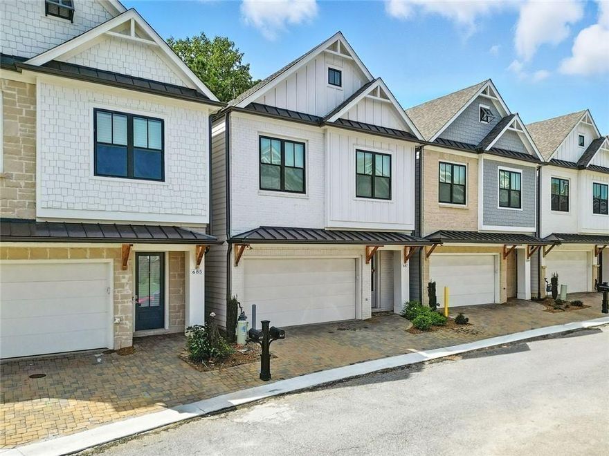 Get a 1/0 rate buy-down for the first year using the Seller's preferred lender! Built in 2023, this clean-lined, modern home delivers standout features from the start. The exterior combines vertical board-and-batten siding, black-trim windows, and natural wood accents that bring warmth and character. Inside, the open-concept layout is bright, functional, and ready for both everyday life and entertaining. At the center of it all, the kitchen makes a strong impression, featuring quartz countertops, a large island with seating, soft-close white cabinetry, and a stainless steel gas cooktop with a statement vent hood. A walk-in pantry, built-in wall oven, and under-cabinet lighting complete the polished look. The open living and dining areas flow together with high ceilings and hardwood floors throughout. Just out back, enjoy two outdoor living options: a ground-level patio perfect for grilling and a private upper deck with access directly from the primary suite. The primary bedroom retreat includes a spa-style bath with a large walk-in shower, double vanity, and a spacious walk-in closet with built-in shelving and storage, keeping everything organized and easy to access. Upstairs offers two more bedrooms, a full bath, and laundry, all tucked into a well-planned layout. Located in a gated community with amenities that include a pool, clubhouse with gym, fire pit, tennis/pickleball courts and three dog parks within the gated areas. Just minutes to Downtown Woodstock’s shops, restaurants, and local events.