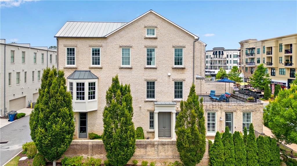 First time to market! Former model home with elevator. This is the largest unit in the Live Work Homes series.
The terrace level offers an expansive private courtyard, huge living/entertaining space, deluxe flex guest suite/office with en suite bath, custom built-in mudroom cabinetry, and access to the 2-car garage.
The main level has a spacious living room with fireplace, gourmet eat-in kitchen equipped with the latest in design trends & professional series appliances, and an oversized, open terrace balcony overlooking all that's happening in Avalon.
The upstairs offers Dual Owner's Suites with custom closet solutions and a stunning view. This is truly a luxurious, private retreat in the middle of all that Avalon has to offer.
The updates and upgrades are endless, including refinished hardwood floors, new carpet in bedrooms, interior painting, remodeled owner’s suite bath, new flooring on the open terrace balcony, elevator, tankless water heater, custom closet solutions, remote controlled motorized blinds, brick accent wall on terrace level, & more!