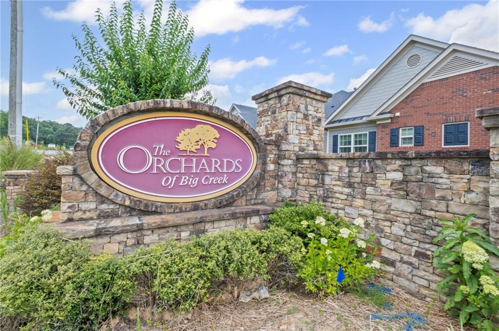 Prepare to be impressed upon entry. Located next to the big creek greenway, perfect for the outdoorsy type. This wonderful 55 plus active intimate community truly is a total gem. The Orchards at Big Creek is situated in the most peaceful setting, one of the most sought after communities in this area. This not your ordinary space, the owner has spared no expense on upgrading this unit. It is just like a model showhouse. If you want that low maintenance lifestyle but still be active, this is your place. New hardwoods, new appliances. new cabinets, new updated lighting just to name a few. This absolutely beautiful home features an open concept, beautiful chef's kitchen with breakfast bar with views to the living area. Nice bright family room with cozy fireplace perfect for those cozy nights. Separate dining room with built ins. Gleaming hardwood floors throughout the main level. Master suite is on the main and features oversized bedroom with ensuite bathroom featuring double vanities, walk-in shower and large walk-in closet. Two more good size Secondary bedrooms one upstairs with full bath and tons of space for entertaining. An additional room off entry can be used as Sunroom/Den/Office or gym, the possibilities are endless. Laundry room is off the kitchen. Double garage with updated storage. Easy access to Vickery where you will always find something fun going on. The Collections, Avalon, Halcyon and nearby restaurants and shopping are all close. Just a mile away is Fowler Park, where you will find biking, walking, exercise facility, pickleball, tennis, etc etc. Also, the residents of Big Creek have access to a variety of their own amenities which are top notch, including a clubhouse, pool and gym. If you are looking for an active adult, friendly community in a fabulous area, this is the place for you.