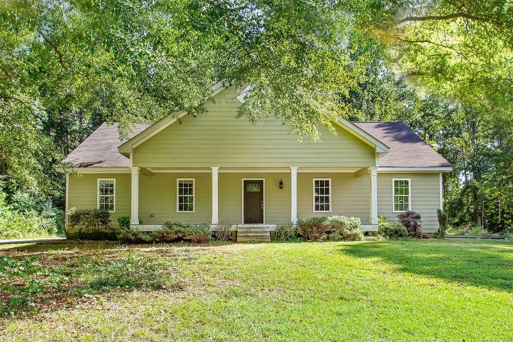 Perfect family home with 1.2 acres, only moments to East-West Connector, and 2 minutes to I-20! This gorgeous ranch home sits well off the road, in the privacy of mature trees. The rooms are spacious, and the floor plan open- perfect for entertaining. The back porch is the perfect place for your morning coffee, overlooking nature in privacy! Inside, you'll find newer appliances, upgraded moulding, a side entry garage, and a spacious laundry room! There is so much room for your garden, animals, or outdoor living spaces! This home is move-in ready! Call today!