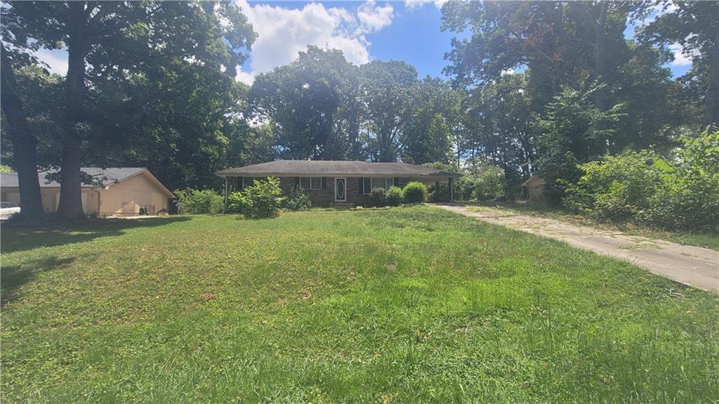 Great Location of Hwy 92 in Cherokee County, with Award Winning Schools.  This home is being sold AS-IS, perfect fixer upper or investment property. 3 bedroom, 2 bath hard to find full brick ranch.  Large front and back yard features a stone and brick fireplace area.  Fenced in backed yard.  So much potential with this home, could be a show stopper with the right updates!  Backyard is private with storage building and back porch is covered and screened in.