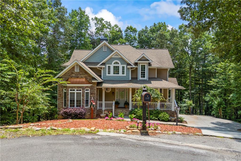 Golf Course Living Meets Mountain Luxury in Helen, GA! Welcome to your dream mountain escape in the gated Innsbruck Golf Community of Helen, GA. Situated on an estate-sized lot with incredible views of not one-but two greens-this custom-built home offers room to spread out, relax, and enjoy resort-style living all year long. With five bedrooms, five and a half baths, and three fully finished levels, this property was designed for multigenerational living, unforgettable entertaining, or maximizing short-term rental potential. Inside, you'll find soaring vaulted ceilings in the main living area and kitchen, creating an open, airy feel. The kitchen is beautifully appointed with solid granite countertops, wood cabinetry, a breakfast nook, and a breakfast bar, while the adjoining formal dining area can comfortably host large gatherings. The main level features a spacious primary suite with an ensuite bath, as well as a flexible second bedroom that could serve as an office, nursery, library, or guest space-also with a full bath. Upstairs, there are two generously sized bedrooms, each with its own full bath and ample closet space. The fully finished terrace level is a standout, offering a second full kitchen, living area, bedroom, full bath, half bath, and a large workshop or art studio. Closets and storage space are abundant throughout the home, making it as practical as it is beautiful. The exterior is equally impressive. This property is beautifully landscaped and tucked under a canopy of trees, providing privacy and natural beauty. A detached backyard deck with a built-in bar overlooks the golf course, creating the perfect setting for three-season outdoor entertaining. A custom-built bocce ball court offers fun and flexibility for your favorite yard games. As a resident of the Innsbruck Golf Community, you'll enjoy access to the championship Innsbruck Golf Club and the upscale Valhalla Resort, featuring a spa, rooftop dining, fitness center, and a saltwater pool at a discounted rate as a resident. Located just minutes from downtown Helen's charming shops, restaurants, hiking trails, and wineries, this home offers the best of North Georgia mountain living. Whether you're seeking a full-time residence, a vacation getaway, or a high-performing investment property, 698 Wilfar Strasse is a must-see! **MUST enter at the Main Front Security Gate for Showings**