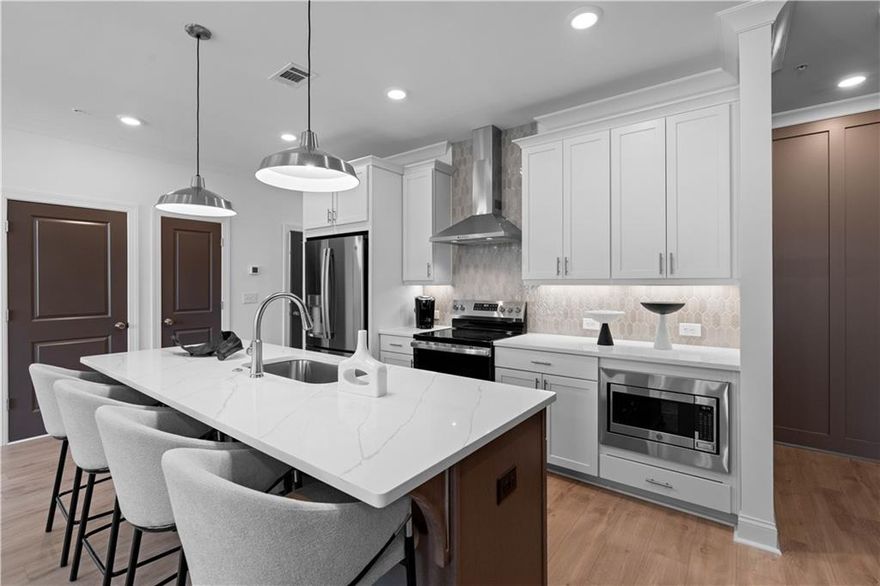 Season of Savings at Market Square! Take advantage of an additional $10,000 toward closing costs on the Magnolia Plan by The Providence Group.
Estimated Completion: January/February 2026

Step into elevated living with this beautifully designed 3-story stacked townhome offering 2 bedrooms, 2.5 bathrooms, and 1,373 sq. ft. of stylish comfort and functionality. Curated with the Warm Wheat Design Collection, this home features Calacatta Prado Quartz Countertops and Riverside Flooring for a warm, sophisticated ambiance.
Terrace Level: A welcoming foyer leads to a convenient laundry area and a private garage equipped with an Electric Vehicle Charger—a modern touch for eco-conscious living.
Main Level: Enjoy seamless flow in the open-concept layout connecting the family room, dining area, and chef-inspired kitchen. Highlights include 42” Off-White Cabinets, a Stained Island, quartz countertops, stainless steel GE appliances, a stylish tile backsplash, and a generous 8-foot island—perfect for entertaining. Step outside to your covered patio, ideal for morning coffee or evening unwinding.
Third Level: Relax in the spacious Primary Suite featuring a walk-in closet and a spa-inspired bath with dual quartz vanities and a walk-in shower with tile surround. A secondary bedroom with its own private bath offers comfort and flexibility for guests or home office needs.
More Than a Home—A Lifestyle.
Located in Forsyth County’s top-ranked school district, Market Square offers future shops and restaurants just steps away, plus walkability to the Cumming City Center for dining, entertainment, and community events. [The Magnolia]