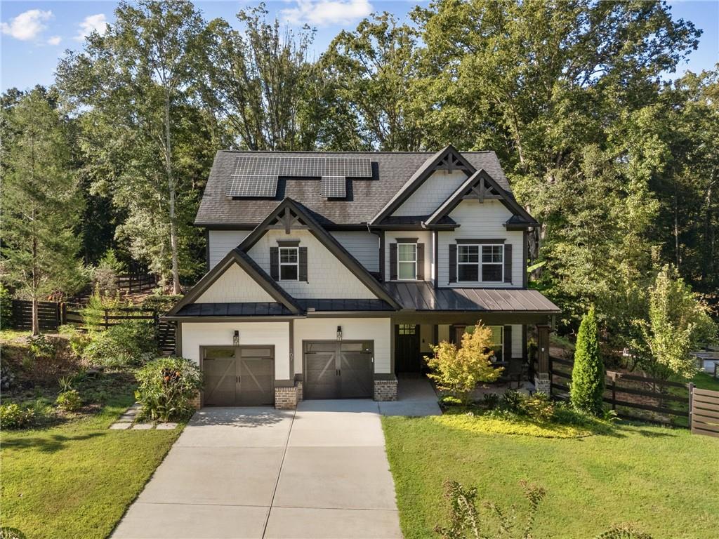 This charming farmhouse-style home blends timeless character with modern comfort, offering a private, low-maintenance lifestyle. From the inviting front porch to the tranquil rear covered patio, every detail is designed for effortless living and entertaining. Inside, hand-scraped hardwood floors and custom finishes create a warm welcome. The open kitchen is the heart of the home, showcasing high-end marble countertops, stainless steel appliances, and an oversized island that flows seamlessly into the fireside family room. French doors open to the covered porch, where you can relax year-round overlooking the sparkling custom pool and expansive, private lot. A flexible bedroom or office on the main floor provides options for guests or work-from-home living, while upstairs you’ll find a serene primary suite, two spacious bedrooms, and an oversized rec room, perfect as a playroom, art studio, or home theater. Every room is beautifully proportioned, thoughtfully designed, and ready for move-in.
Outdoors, the property is just as impressive. In addition to the pool and relaxing porches, there’s a substantial storage building, large enough for a tractor, workshop, or hobby space. Meticulously maintained by its original owner, the home feels like new and is decorated to perfection with upgrades throughout.
If you’ve been searching for a home that combines privacy, flexibility, and everyday ease, this one is move-in ready and waiting for you.