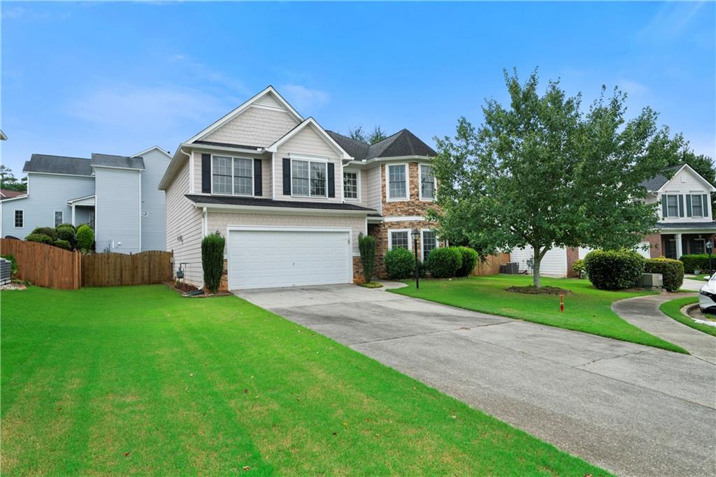 This beautiful stone accented home is located in the desirable Overlook subdivision. This Cul-de-sac home is located convenient to I75 and I85. This open and bright floor plan has beautiful hardwood floors throughout the majority of the main level. The entry foyer opens to the formal living and dining rooms. The spacious kitchen has an island and overlooks the family room. The kitchen and all baths have lovely cherry-stained cabinets. The over-sized master suite has a sitting area. The fenced back yard affords privacy and is perfect for kids and pets. The paint, hardwood floors and carpet are relatively new. Only a 5 minute walk to the Chattahoochee River and Dog Park. It is easy access to the new Roger's Bridge walking bridge/trail and Cauley Creek Park.