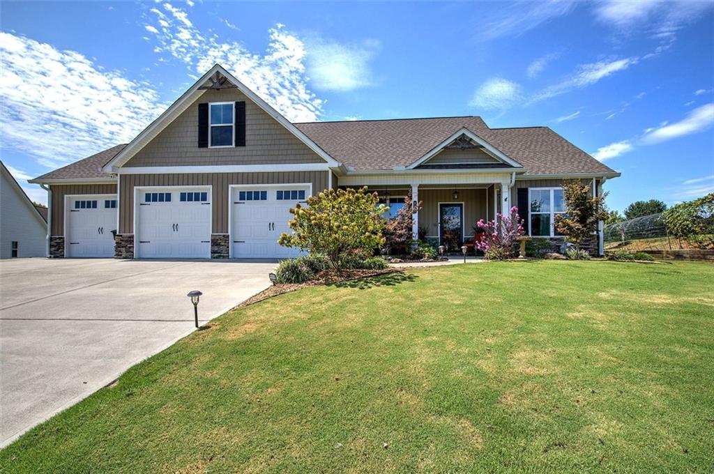 Discover a truly one-of-a-kind home that blends thoughtful design, modern comfort, and timeless character. Only five years old, this beautifully crafted residence showcases numerous upgrades, including rich engineered hardwood floors, a whole-home attic fan, and an oversized three-car garage—with two bays extended to 24.5 feet deep for added versatility.
The open-concept floor plan is a showstopper, featuring a stunning kitchen with stainless steel appliances, an expansive bar with seating, and generous workspace for the home cook or advanced chef. It seamlessly flows into the main living areas, making it ideal for entertaining and everyday living.
The inviting master suite is a retreat of its own, highlighted by a 150-year-old cast iron soaking tub and a custom-tiled shower. Upstairs, a spacious bonus room above the garage offers endless possibilities, including the potential for an additional bath.
Set gracefully on a manicured cul-de-sac lot, this craftsman-style home enjoys an elevated presence framed by fruit trees, berry trellises, and lush landscaping. Step outside to a 12x16 covered patio—perfect for morning coffee or evening gatherings.
Every detail of this home was thoughtfully considered to create comfortable, efficient living, and now it’s ready to welcome its next owners. Don’t miss this rare opportunity—homes like this are a true find.
