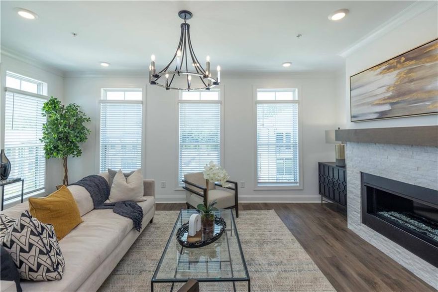 ~END UNIT~ Spring into a New Home with The Providence Group! Discover the perfect blend of modern design and everyday comfort in this beautifully appointed 3-bedroom, 2.5-bath townhome. Thoughtfully crafted with upscale finishes and flexible living spaces, this home is ideal for today’s dynamic lifestyle. You'll be welcomed with a private front entrance, fenced-in yard, and a covered terrace with an outdoor gas fireplace—a peaceful space to unwind or entertain in style. Step inside to a versatile ground-level flex room, perfect for a home office, workout space, or media room. Dual access through the front door and sliding glass doors fills the space with natural light and offers endless possibilities. Upstairs, the main living area boasts an airy open-concept layout that seamlessly connects the living, dining, and kitchen spaces. At the heart of it all is a chef-inspired kitchen featuring a generous island with Quartz countertops, 42” shaker-style cabinets with crown molding and soft-close doors, and GE stainless steel appliances. Just off the living space, a sunroom with access to a private wooden deck offers the perfect setting for morning coffee or evening cocktails. The upper level is home to a tranquil owner’s suite with a spa-like bath, featuring a separate rub and shower and walk-in closet, along with two additional bedrooms, each with access to their own shared outdoor deck, providing privacy and charm. For a limited time, you'll be able to personalize your dream home with one of our design packages created by our award-winning design team. Location is key, and this townhome delivers—nestled just minutes from Avalon, Downtown Alpharetta, and within walking distance to Top Golf, The Cooler, and everyday conveniences. Whether you’re grabbing a bite, shopping, or enjoying a night out, everything is within easy reach. Under Construction. Photos and Virtual Tour are of previously built Benton Plan.  Estimated Completion: December 2025. [The Benton I]