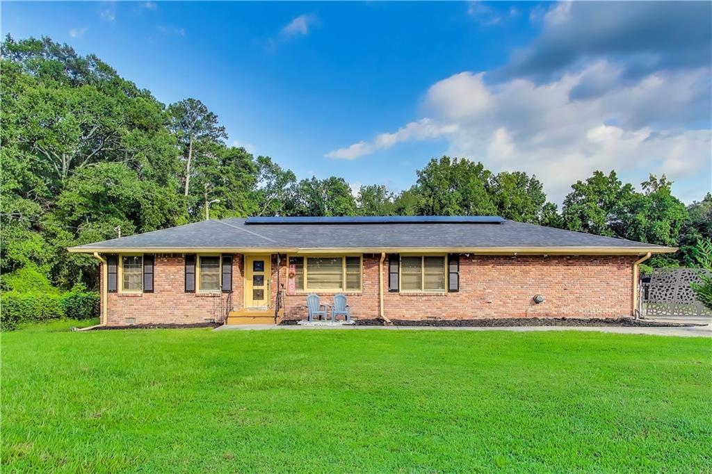 This beautifully maintained ranch style home offers 1,831 square feet of comfortable living space on a generous 0.74 acre leveled lot. With four sided brick construction, solar panels on the roof, and no front neighbors, you'll enjoy both durability and privacy while still being close to the city. Inside, the freshly painted interior features a remodeled kitchen with granite countertops, tile flooring, stylish backsplash, and painted cabinets, as well as updated light fixtures throughout. The hardwood flooring adds warmth, while the bedrooms offer cozy carpeting. The bathrooms have been beautifully remodeled with ceramic finishes for a modern touch. A new water heater ensures efficiency, and the spacious layout includes a long driveway, a huge front and back yard, and a fenced backyard for added comfort. Relax on the nice sized patio, take a short walk to English Park, or enjoy being minutes away from restaurants and stores. This gem is move in ready and waiting for you to call it home.