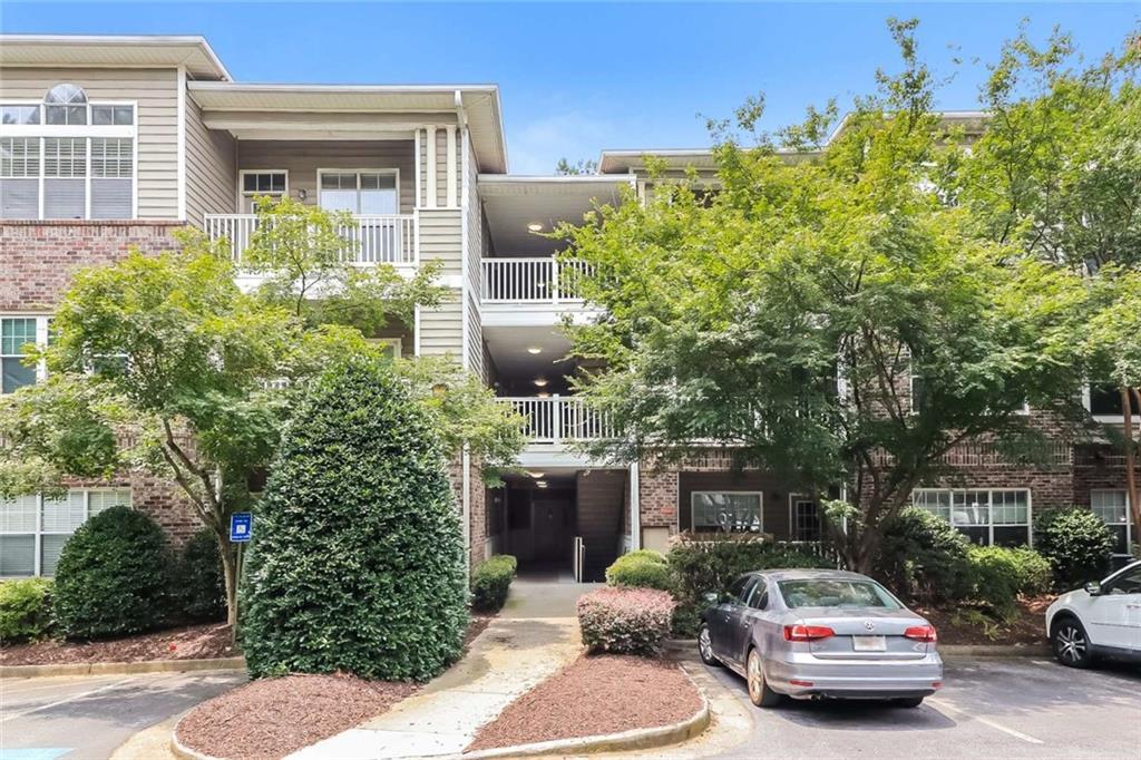 Welcome home to this freshly renovated first floor Condo located in the desirable Carrington Park community! Featuring 2 bedrooms, 2 full baths, covered balcony, and covered designated parking. Spacious interior with new laminate plank flooring throughout, new stainless-steel appliances and all new light fixtures. Open Kitchen with granite countertops and stainless steel undermount sink. Bathrooms feature bright white cabinets and stone countertops with a large soaking tub in the Master. Large walk-in closets. Community features gated entrance and abundance of unassigned parking for guests, pool, gym, grill by the pool, and theater room in the Clubhouse. Approximately 2 miles from Lenox Mall with great access to 85 & 400. Monthly dues include water. Come make this perfect condo your home!