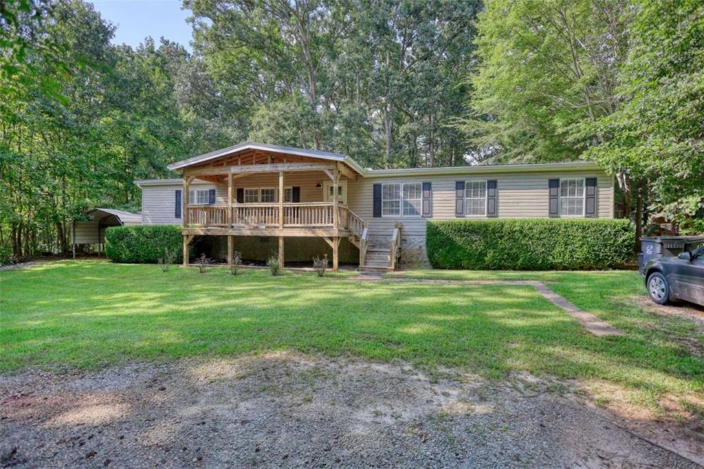 Charming 3-bedroom, 2-bath home in the desirable Turtle Cove community near Lake Jackson. This inviting split-bedroom floor plan offers stylish LVP flooring with cozy carpet in the bedrooms. The spacious family room features a fireplace and opens kitchen & dining room, perfect for gatherings. The kitchen is beautifully appointed with leathered granite countertops, stainless steel appliances and plenty of storage. Enjoy outdoor living on the large front porch, screened porch overlooking the private backyard, or the deck designed for entertaining. A carport and outbuilding provide extra convenience and storage. Just a short walk to Lake Jackson, this home also gives you access to Turtle Cove amenities including a clubhouse, pool, and 9-hole golf course.
