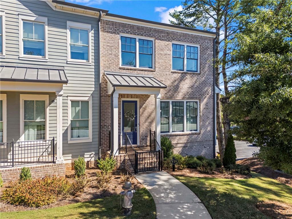 Welcome to one of Roswell’s most charming communities, Canopy! This like-new 3 bedroom, 3.5 bathroom end unit townhome offers a rare private fenced side yard and lives large with bright, open spaces + thoughtful upgrades throughout. The main level is both open and inviting, featuring a fireside living room, dining room, and a chef’s kitchen with a large island, bar seating for four, a large walk-in pantry, and stylish pendant lighting. Also found on the main level is an office or study nook plus a half bath. Don't miss the sizable outdoor deck, perfect for morning coffee or evening happy hour. Upstairs you’ll find a primary suite that offers a large custom walk-in closet and a spa-like bathroom with dual vanities. Two spacious secondary bedrooms, a secondary bathroom, and laundry complete the second level. The finished terrace level is a special treat for movie night! It features a full bathroom and barn doors that lead to a fourth bedroom, a home office, or gym. The oversized two-car garage offers excellent storage + a Tesla EV car charger. A community dog park is loved by many! Enjoy unbeatable access to local favorites with Roswell Junction, Summit Coffee, The Mill, and Souper Jenny just minutes away—and the beloved shops and restaurants of Canton Street only a short distance from your door.